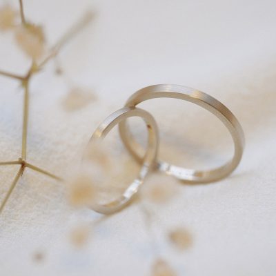 Par de alianças de ouro 18k na tonalidade champagne sobre pano branco