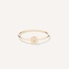 Anel de aro fino minimalista feito a mão em ouro 18k com diamante no centro sobre tecido branco