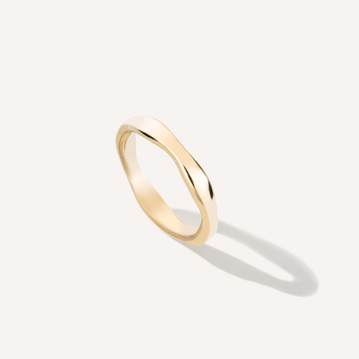 Aliança irregular orgânica minimalista feita a mão em ouro 18k para casamentos sobre fundo branco