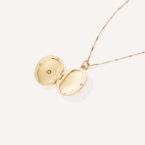 Corrente com pingente relicário em formato oval minimalista feito a mão em ouro 18k com diamante no lado de fora e dois espaços para foto