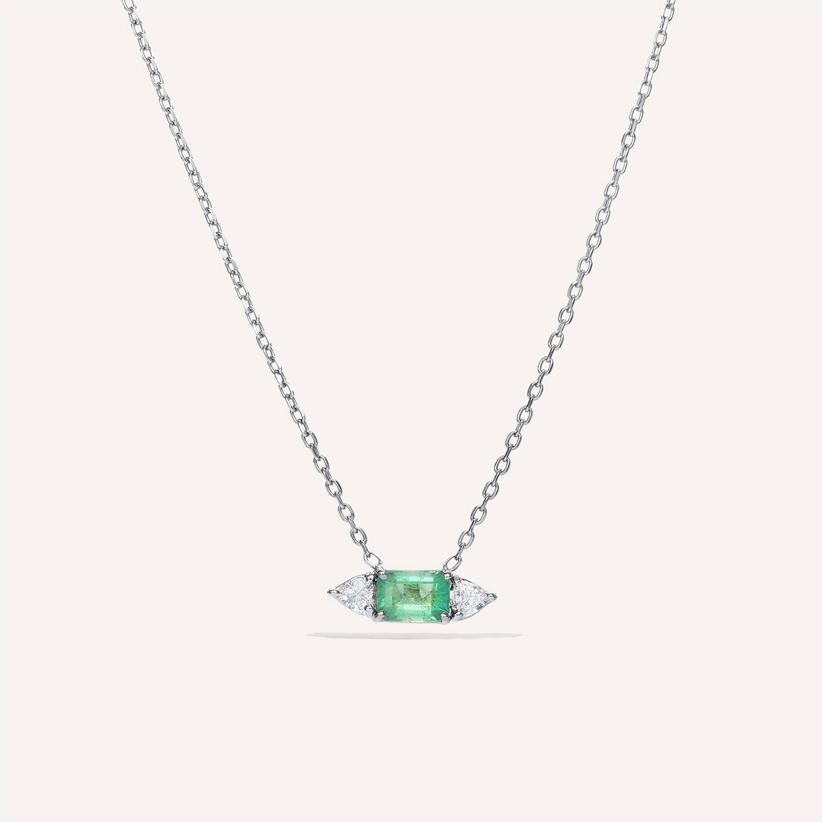 Colar em ouro branco 18k com esmeralda central e diamantes trillion laterais da Joias Liê