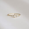 Anel minimalista em ouro 18k com um diamante central e dois diamantes laterais menores
